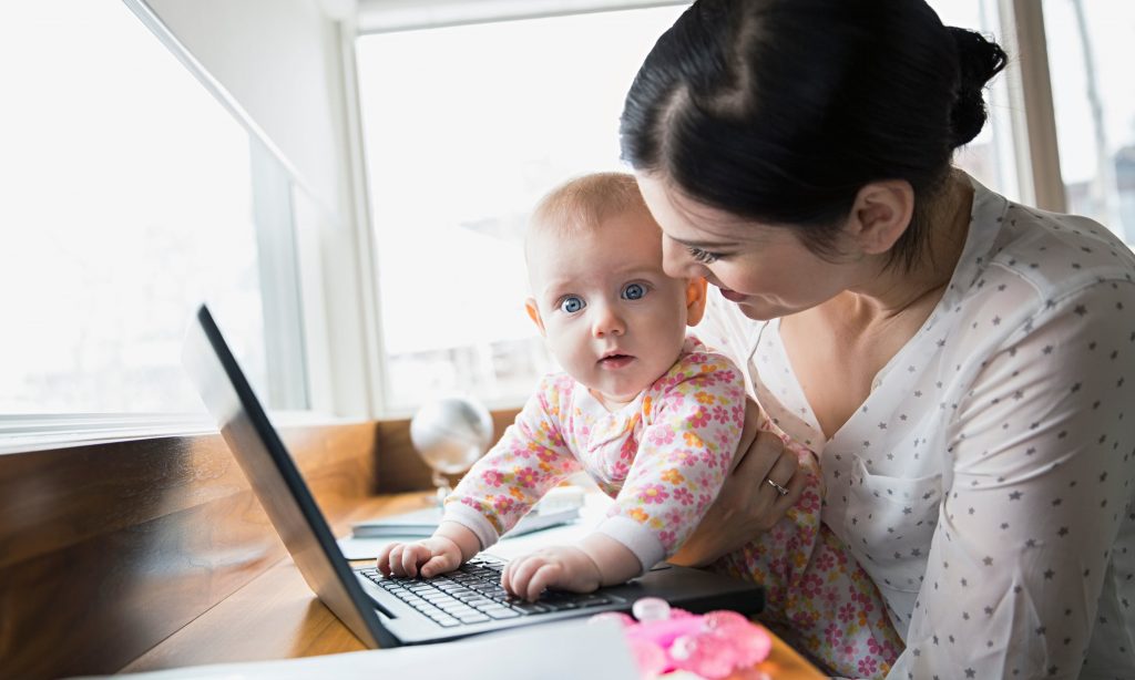 Mother and baby at laptop in home office